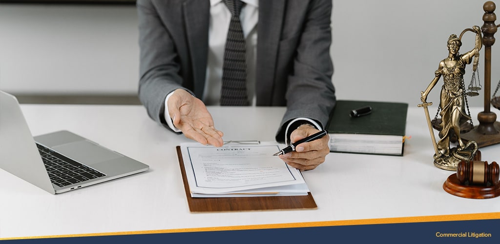 Man sitting in front on contract, Commercial Litigation