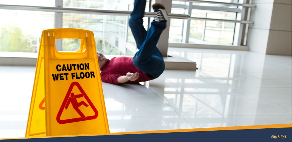 Man falling behind a caution wet floor sign, Premises Liability Lawyers