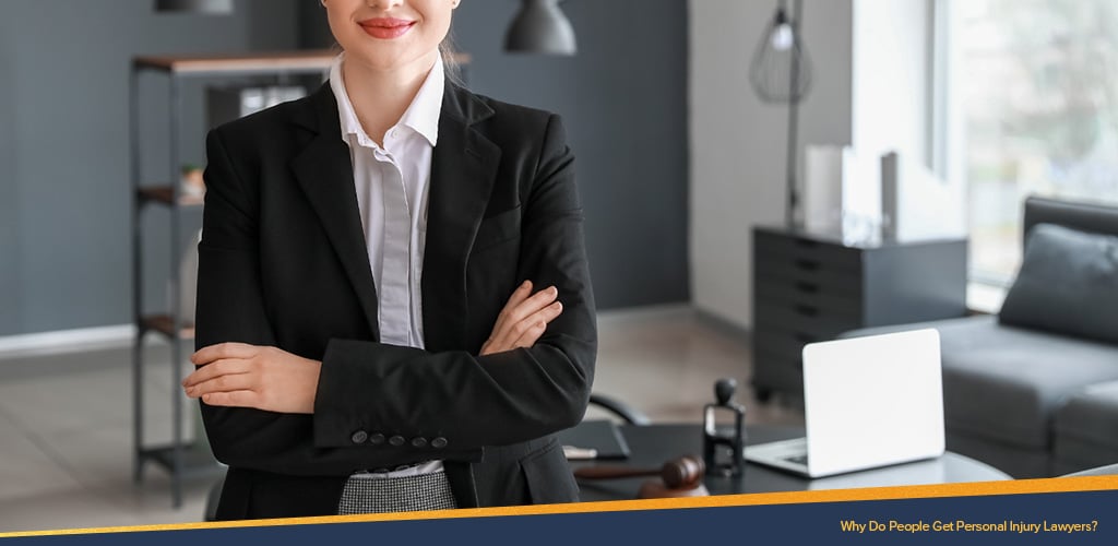 Female Lawyer standing in an office, Why Do People Get Personal Injury Lawyers?